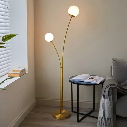 Floor lamp in brushed gold finish with white glass shades