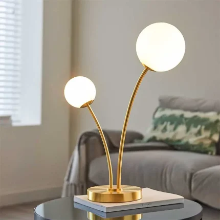 Table lamp in brushed gold finish with white glass shades