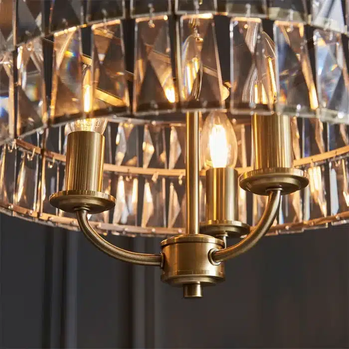 3 light pendant light in antique brass finish with clear glass