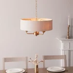 Pendant light in aged brass finish with natural linen fabric shade