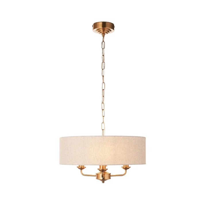 Pendant light in aged brass finish with natural linen fabric shade