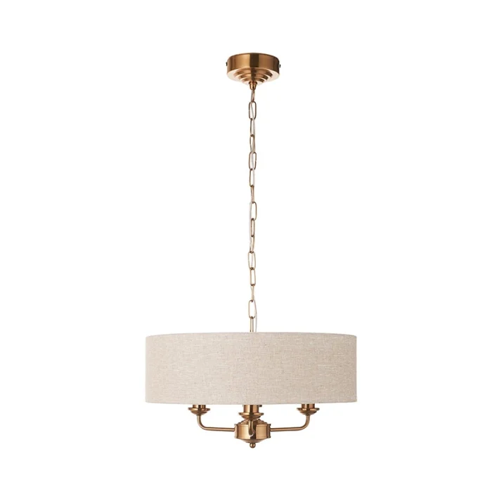 Pendant light in aged brass finish with natural linen fabric shade