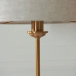 Table lamp in aged brass finish with natural linen fabric shade