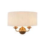 Wall light in aged brass finish with natural linen fabric shade