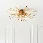 Antique brass plated flush ceiling light in starburst design for sitting room. living room and hallway