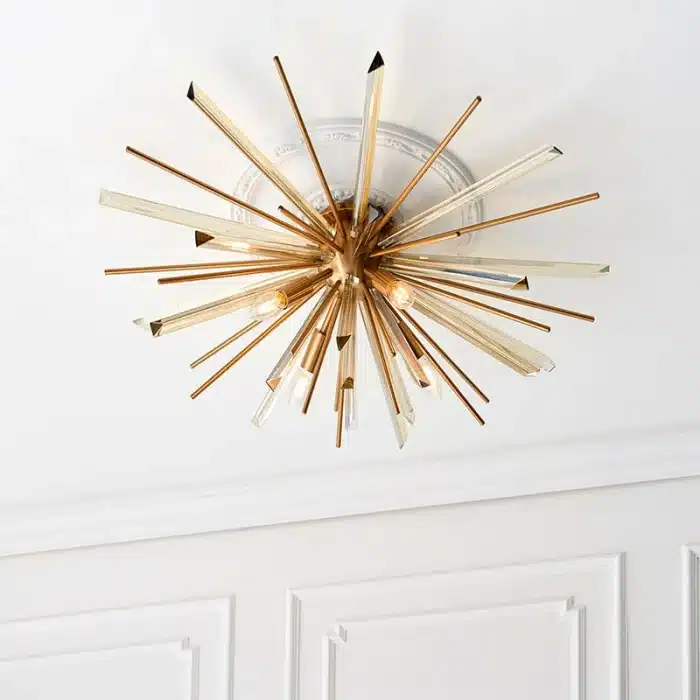 Antique brass plated flush ceiling light in starburst design for sitting room. living room and hallway