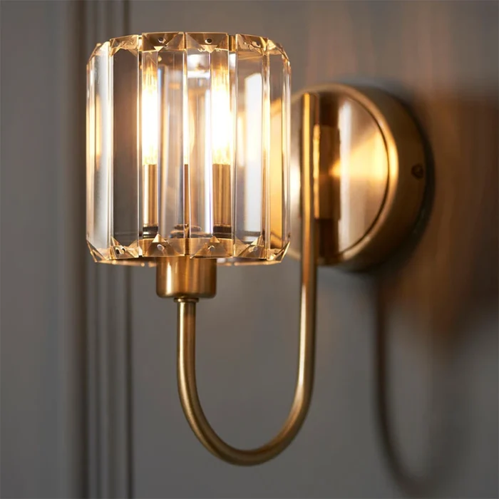 Wall light in antique brass plated finish