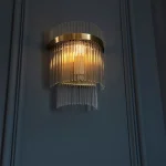 Wall light in antique brass plated finish with clear glass rods