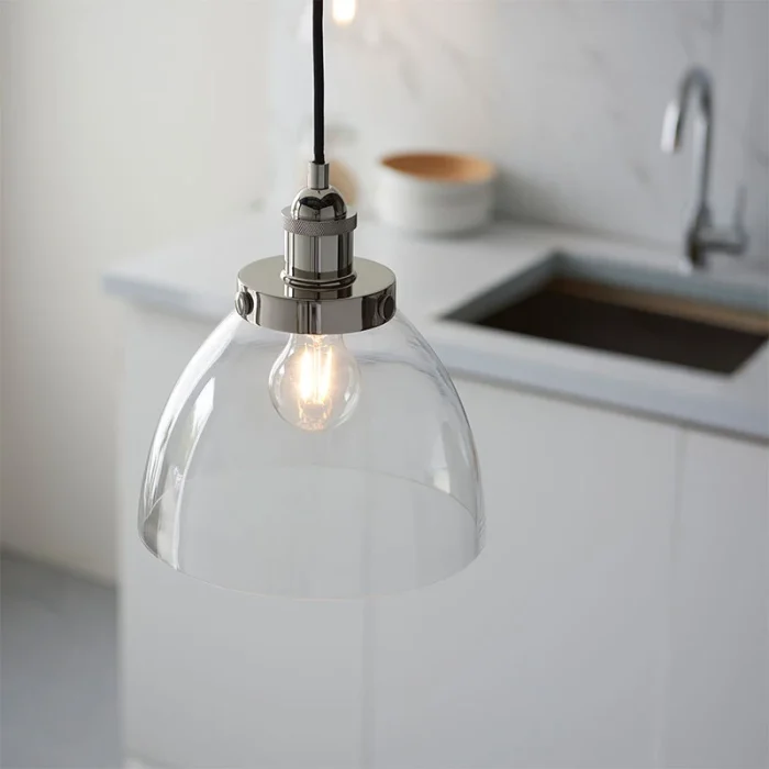 Single pendant light in bright nickel finish with clear glass shade