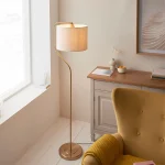 Floor lamp in brushed aged brass finish with natural linen fabric shade