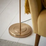 Floor lamp in brushed aged brass finish with natural linen fabric shade