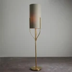 Floor lamp in satin brass finish with natural fabric shade