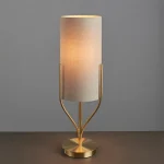 Table lamp in satin brass finish with natural linen fabric shade