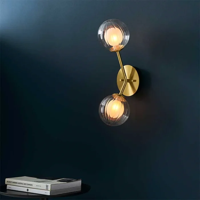 Wall light in satin brass finish with clear ribbed glass