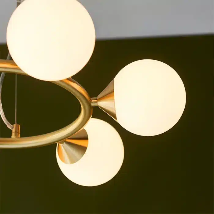 Rind design pendant light in satin brushed gold finish with gloss white glass shades